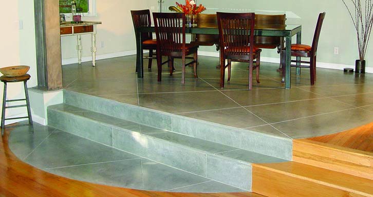 GLC3 Concrete finished concrete in a dining room made a circle of light gray concrete cut to mimic tile as it flows down the stairs.