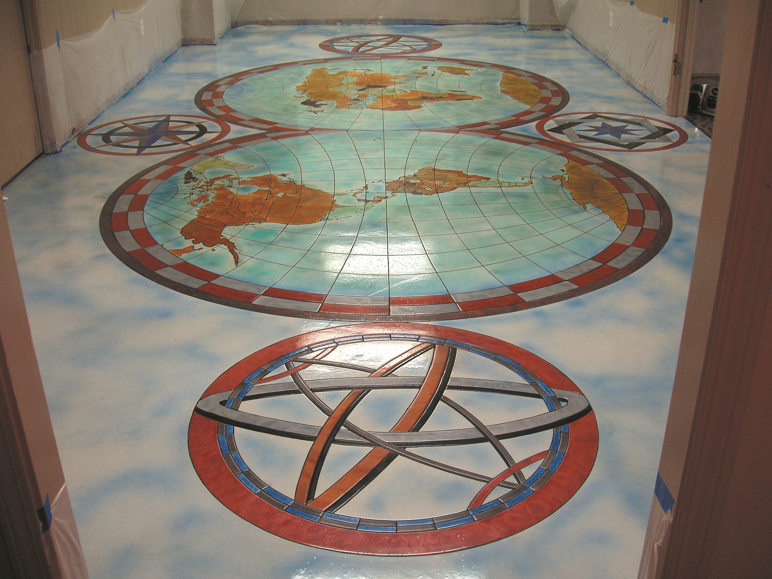 Skim coated floors with dyes, stains and epoxies. The blue variations and the sky on the floor to the left were all created with dyes.
