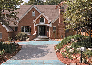 Larfarge Artevia Decorative Concrete - Artevia concrete is integrally colored with a palette of earthy tints that can be customized to fill special orders. The palette offers 38 colors in the United States, 18 in Canada. Colors used on the driveway of the brick home.