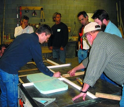 Jeffrey Girard of the Concrete Countertop Institute shows a group of students how to layout a sink mold prior to precasting a concrete countertop.