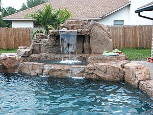 Concrete faux rock pool - This waterfall combines modular technology with older structural methods using rebar and concrete.