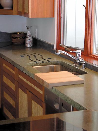 Lokahi Stone - full kitchen concrete countertop with a waterfall edge in grayish green color.