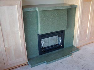 Variegated precast concrete gray fireplace mantle, stoop and surround.