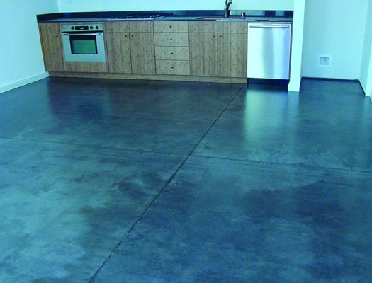 Concrete floor in new apartment building was too damaged for regular concrete stains so the contractor used a polyurea floor coating to mask the damage and stains.