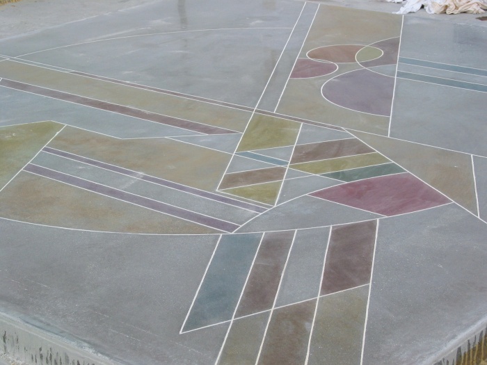 a dyed and polished concrete patio with geometric patterns