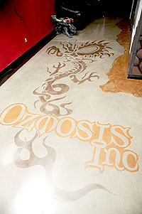 Floor Seasons used a stencil to get the Ozmosis Inc logo on the concrete floor.