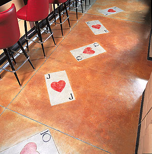 Playing cards are engraved and colored on this concrete floor.