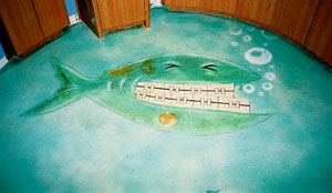 Acrylic acids were used to stained a fish with braces on this concrete floor.