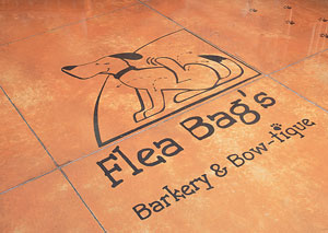 Flea Bag's Barkery and Bow-tique logo stained concrete logo.