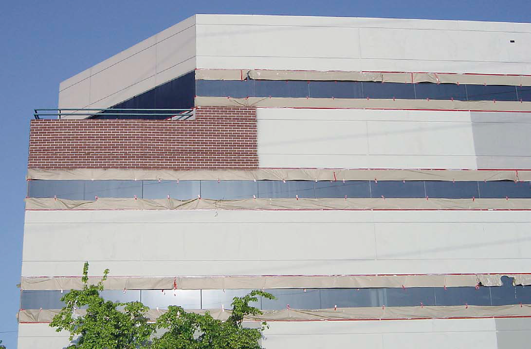After using window-washing equipment to scale the sides of the 15-story office building, Scotts crew used lasers to get their lines straight. Starting at the top and working their way down, they also did what they could to square their pattern with pre-existing joints in the poured-in-place building. The old hand-cut joints werent exactly laser straight.