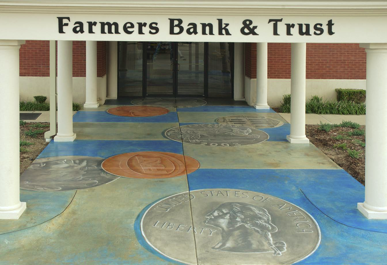 Bank entrance that has been stained with images of coins.