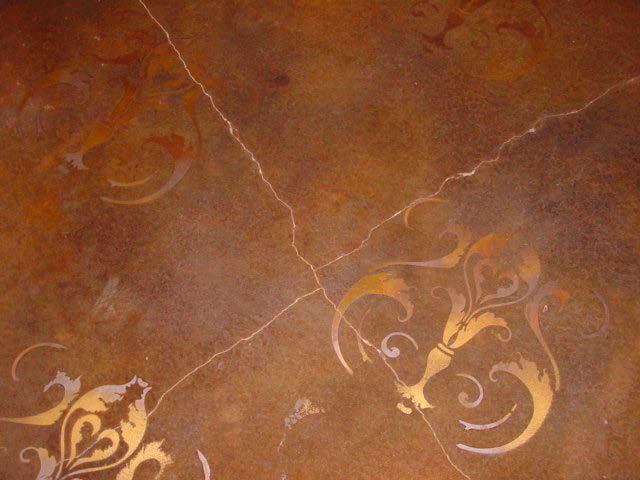 Stained concrete floor with metallic stenciled designs.