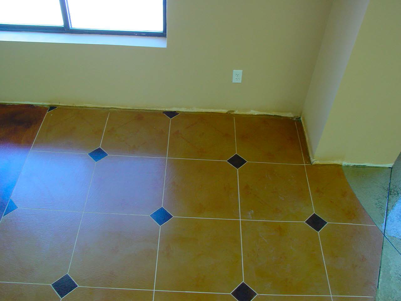 Tile like microtopping with black diamond pattern.