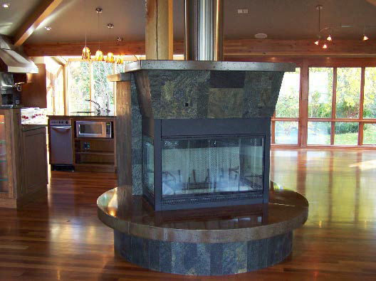 Concrete surrounds this wood burning fireplace.