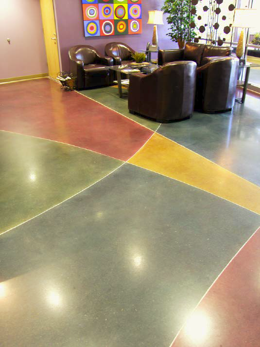 Colored concrete floor that has distinct line differences engraved.