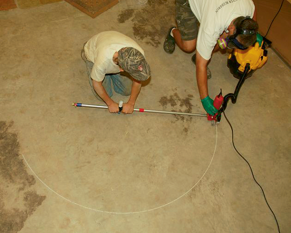 Two people are cutting concrete following the pattern made with the quick draw design and layout too.