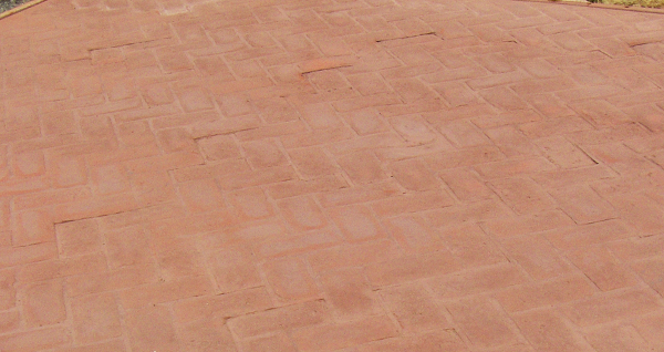 Brick-like stamped concrete has been colored with dust-on color hardener.
