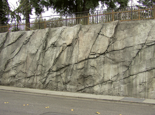 Large natural stone looking retaining wall made of concrete.