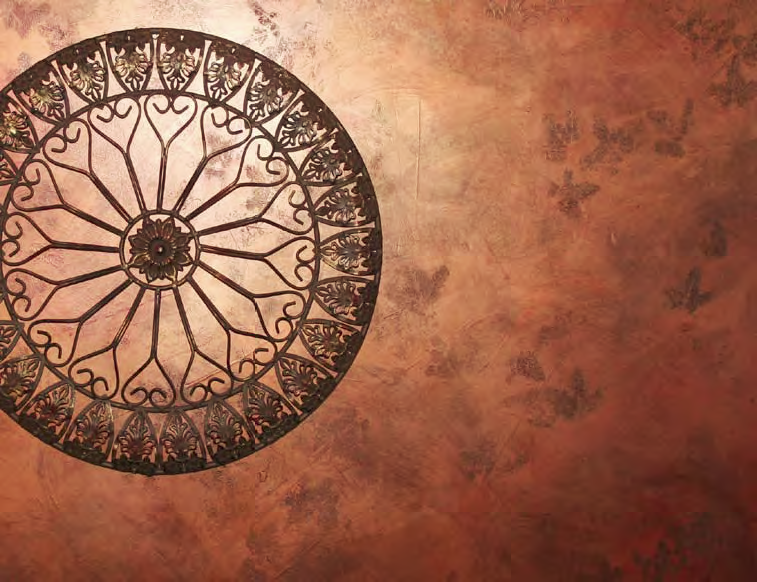 Decorative design placed on a red faux painted wall.