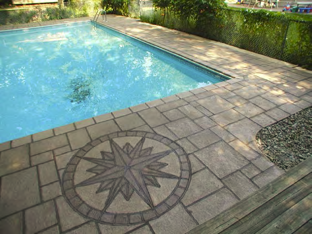 A compass rose is placed in the stamped concrete pool deck providing just the right element of design.