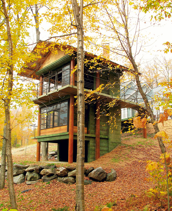 A concrete treehouse in the forest with all the fall colors making it pop.