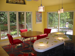 White concrete countertop with colorful inlays in lime green, yellow, and red.