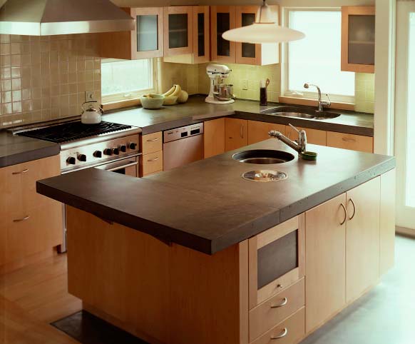 Precast concrete countertop in a kitchen with a huge island.