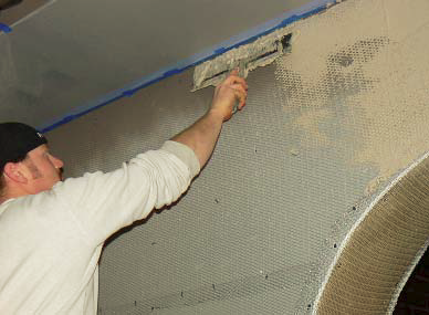 Ryan Siebol of KW Specialized Construction uses a flat trowel to apply a vertical application.