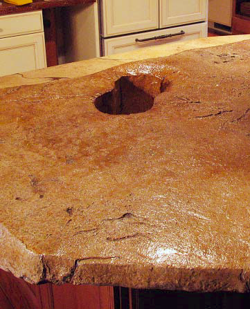 Concrete countertop in brown with a place to put wine bottles.