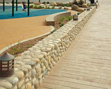 Faux stone sitting wall that delineates two spaces of this park.