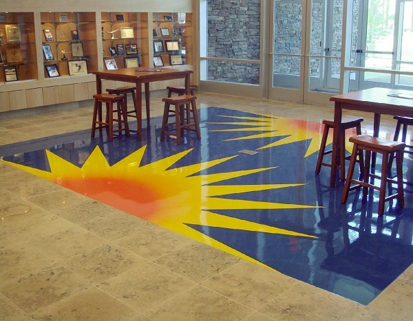 Concrete floor with vibrant sun design on a blue background