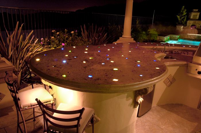 A concrete countertop that is lit with fiber optics and glass aggregate.