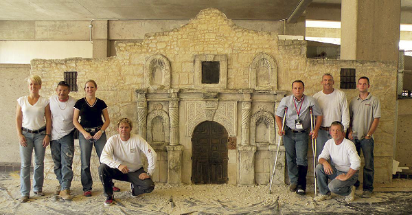 Group of conference attendees in front of their carved alamo.
