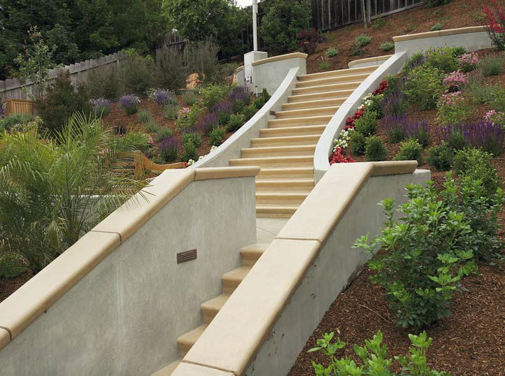Stairs lead the homeowners on this three tiered concrete patio.