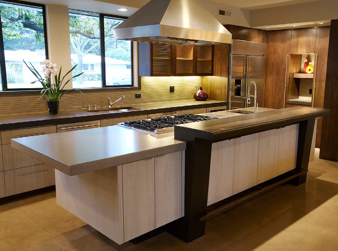 A complete concrete kitchen with countertops and decor that create this perfect central point to this concrete home.