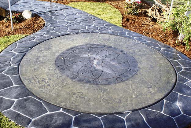 Circular patio with a wandering path made of stamped concrete.