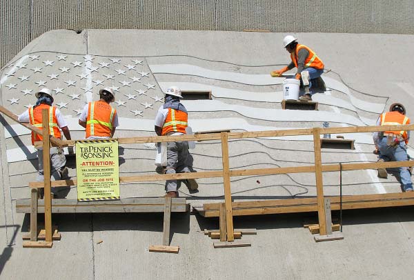 Contractors at work using concrete to create an American Flag. Photo courtesy of T.B. Penick & Sons Inc.