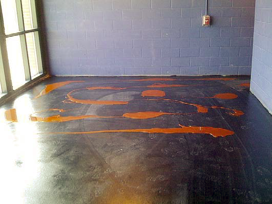 An in process shot of the floor being stained with Relfector Enhancer by Elite Crete.