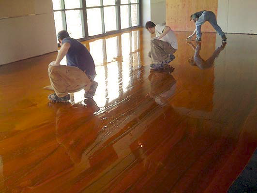 Three contractors working on a stain installation.