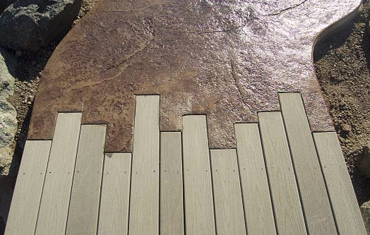Concrete and Trex deck meeting up together to make a seamless transition between the two building materials.