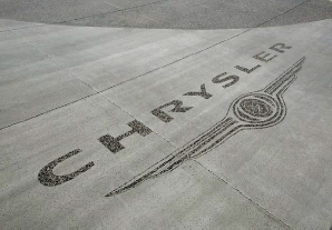 Black glass was seeded into freshly poured concrete pads at a Las Vegas auto dealership. Chrysler logo. Photos courtesy of Chief Concrete.