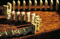 Dominoes lined up and ready to fall.