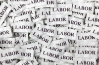 A pile of paper with the word labor on it