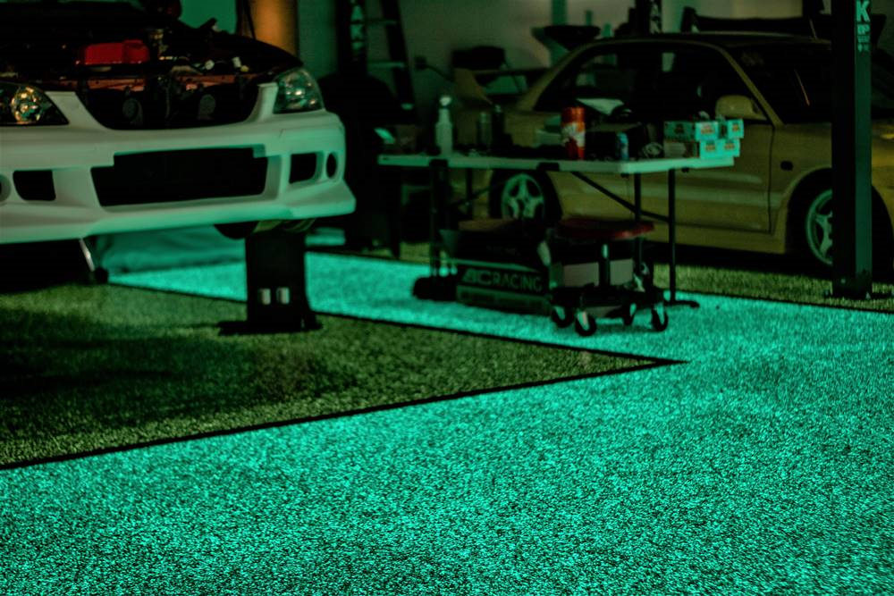 A close-up of a concrete floor that is glowing in the dark using Laticrete products