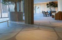 A hotel with stenciled concrete floors