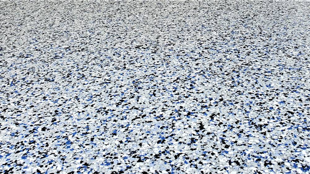 broadcasting vinyl chips in blues blacks and whites creates a terrazzo like look