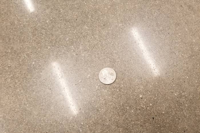 A coin on a polished concrete floor.