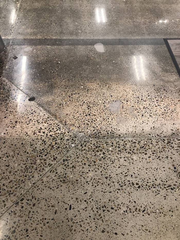 A concrete floor that has binder colors that become more pronounced when polished.