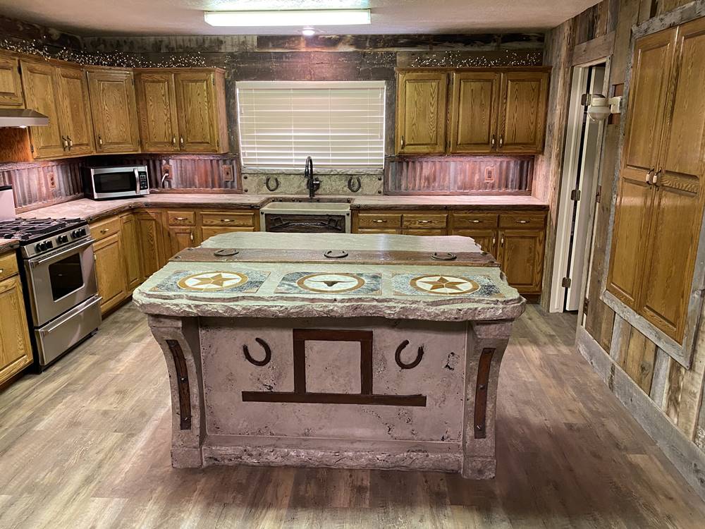a rustic kitchen with custom concrete countertops