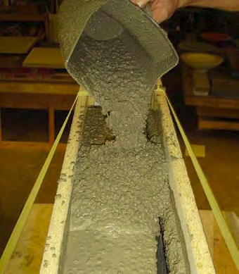 A fluid concrete mix for wet-casting is characterized by high slump and high fluidity.